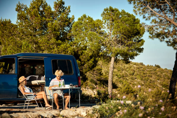 istock Couple resting after road trip by van on mountain 1003593114