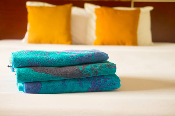 istock Stacked towel and new bed sheet in the hotel for customer 1003595004