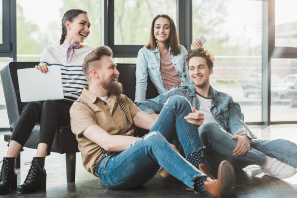 istock Successful business people sitting and resting together in modern light office 1003598642