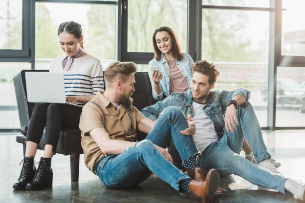 Successful business people resting and using gadgets in modern light office