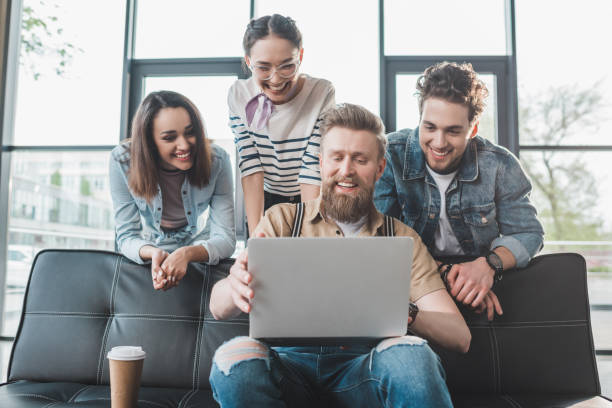 istock Diverse business team looking at laptop in light workspace 1003599016