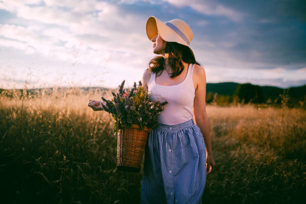 istock Stunning young woman walking through a golden meadow 1003600230
