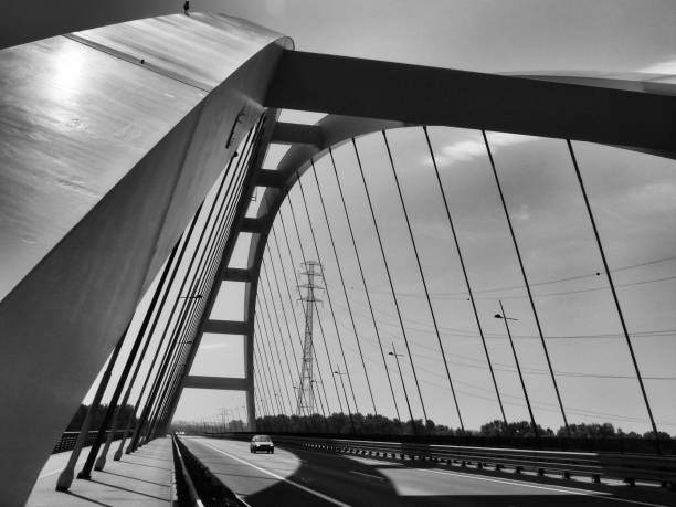 istock steel suspension bridge in abstract view with sky and clouds 1003602828