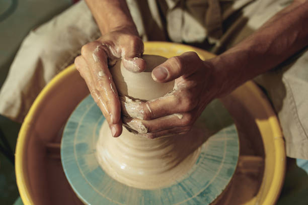 istock Creating a jar or vase of white clay close-up. Master crock 1003604990