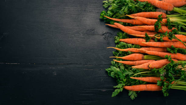 istock Fresh Carrot. Fresh vegetables. On a wooden background. Top view. Copy space. 1003609050