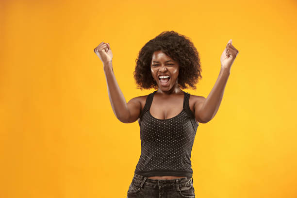 istock Winning success woman happy ecstatic celebrating being a winner. Dynamic energetic image of female afro model 1003610772