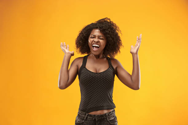 istock Winning success woman happy ecstatic celebrating being a winner. Dynamic energetic image of female afro model 1003610938