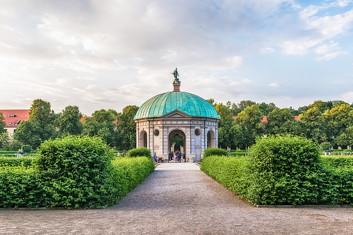 Munich, Germany June 09, 2018: Hofgarten Park with Dianatempel in Munich. People meander about the Diana Pavilion and the grounds of the Hofgarten, adjacent to the Munich Residenz and Odeonsplatz.