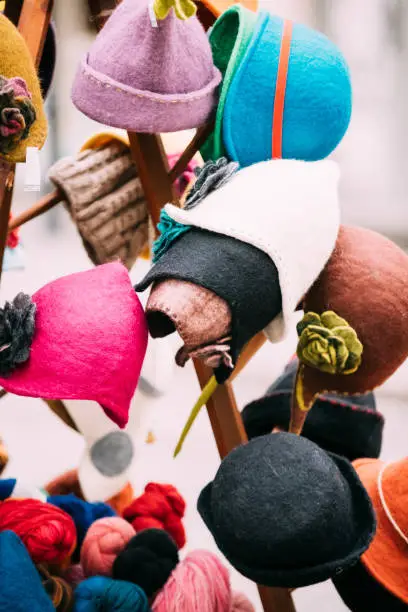 Photo of Colorful Traditional European Caps Hats At Winter Christmas Market. Souvenir From Europe.