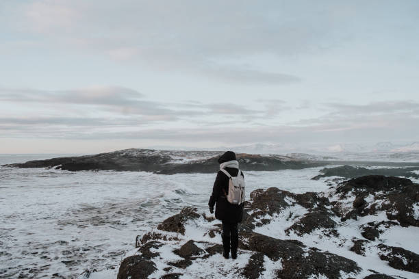 istock A person walking in Stokksnes, Iceland 1003618254