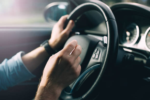 istock business car driver. Hands on the steering wheel while traveling behind the wheel. 1003623832