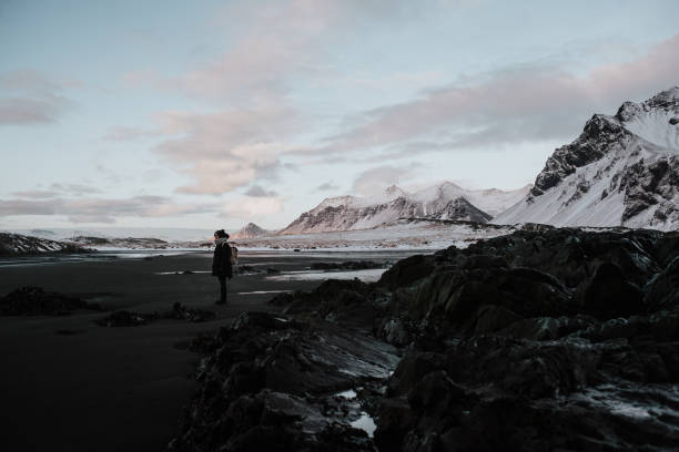 istock Person standing on a black sand beach in Stokksnes, Iceland 1003629088