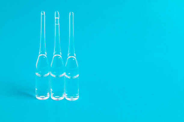 istock Medical syringe and drusg on blue background. Top view with copy space 1003631202