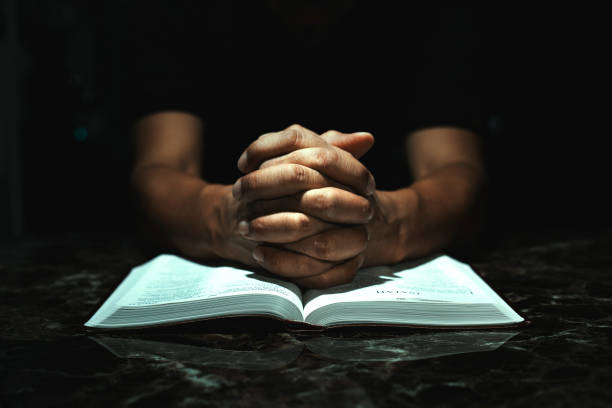 istock Men praying to God on his desk 1003633774