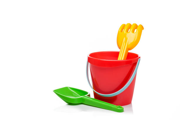 istock Sand bucket, pail and shovel isolated on reflective white background 1003635486