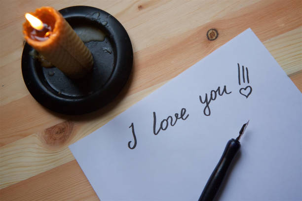 istock Love letter on white paper and candle. 1003638132