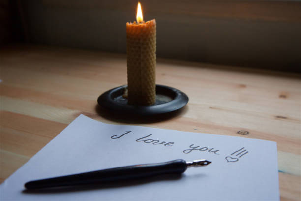 istock Love letter on white paper and candle. 1003638196