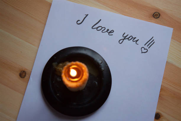 istock Love letter on white paper and candle. 1003638232