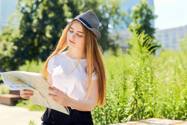 istock Girl with map standing on the street 1003643722