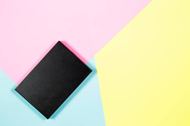 istock Black plastic box was are external hard drive on the color paper. 1003647620