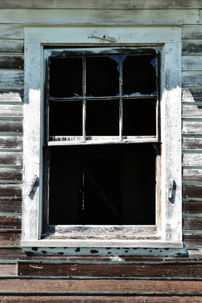 istock Old Weathered and Broken Wooden Window 1003648260