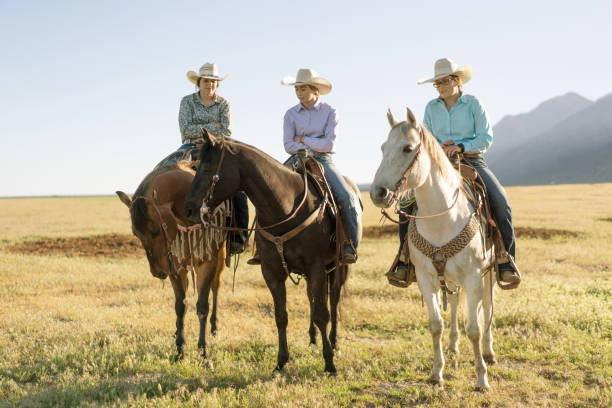 istock Cowboys Horseback Riding at sunrise 1003648442