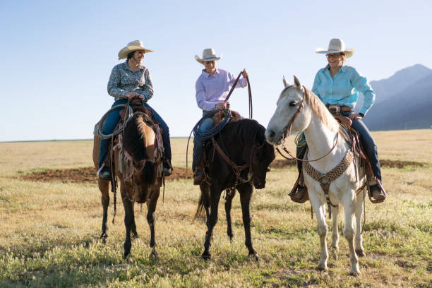 istock Cowboys Horseback Riding at sunrise 1003648546