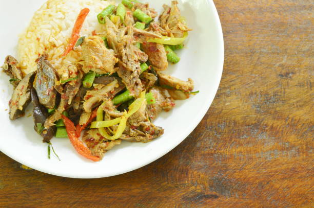 istock spicy fried duck meat curry with basil leaf and rice 1003648604