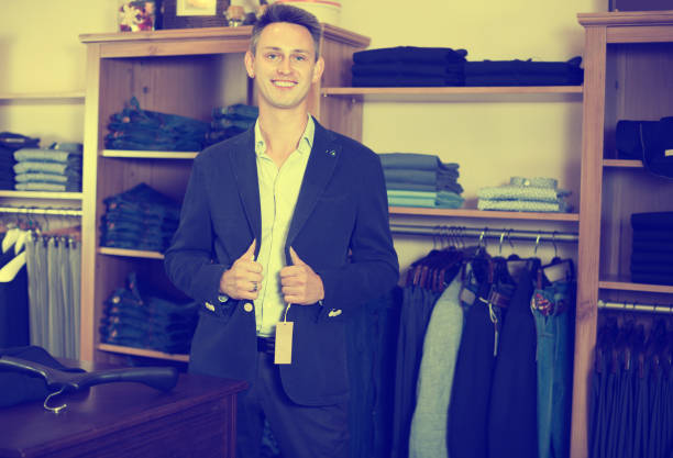 istock Smiling male customer searching new suit 1003655856