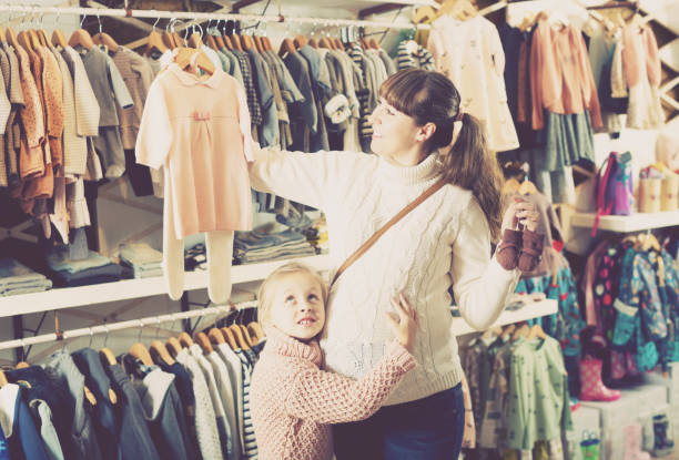 istock Pregnant woman examining baby's clothes 1003668754