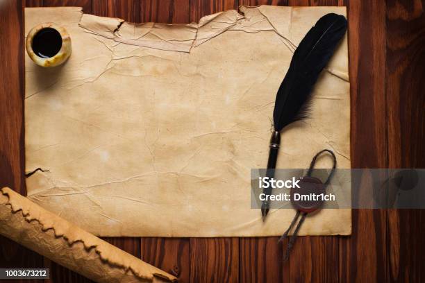 White Goose Feather And Inkwell Scroll On The Background Table Stock Photo - Download Image Now