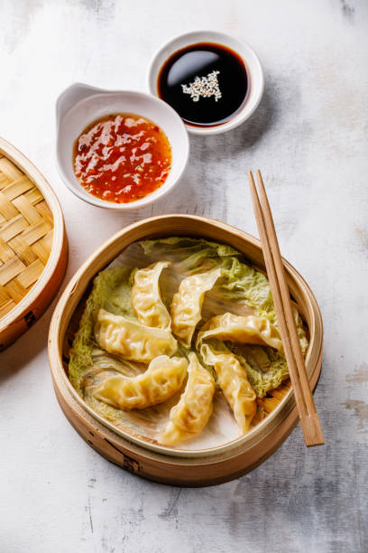 istock Gyoza dumpling in bamboo steamer and sauce 1003675806
