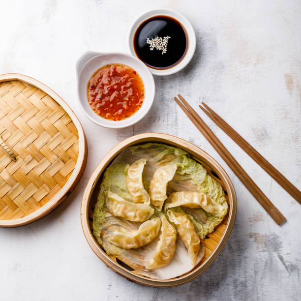 istock Gyoza dumpling in bamboo steamer and sauce 1003675826