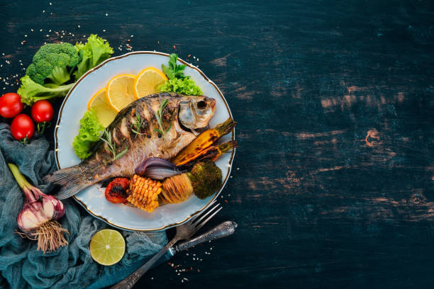 Baked fish carp. On a wooden background. Top view. Copy space. Baked fish carp. On a wooden background. Top view. Copy space. carp stock pictures, royalty-free photos & images