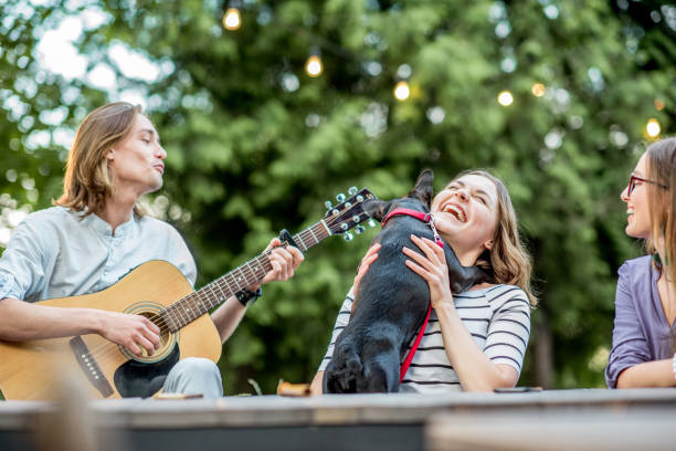 istock Happy friends with guitar outdoors 1003717582