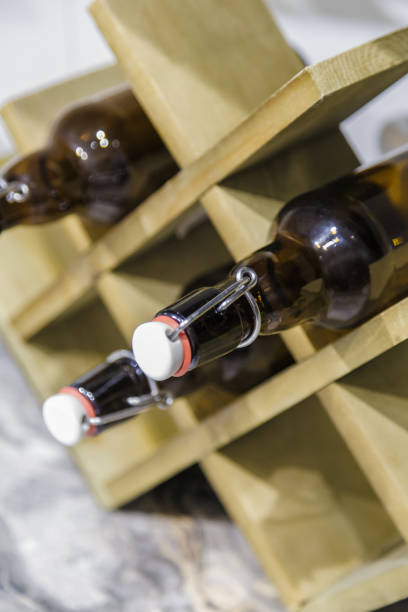 istock Wooden stand for bottles on the table in the kitchen 1003718332