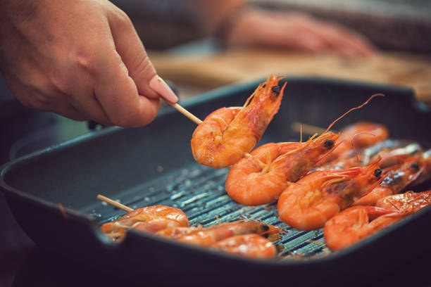 istock Young Women Preparing Shrimps at Home 1003734846