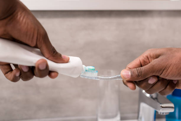 istock cropped shot of man applying toothpaste onto brush 1003735622