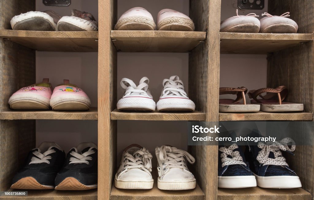Indoor Shoe Rack of sneakers lovers shoes. Indoor Shoe Rack of sneakers lovers shoes for children Shoe Stock Photo