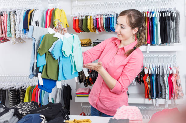 istock woman is choosing  clothes for  kid 1003735954