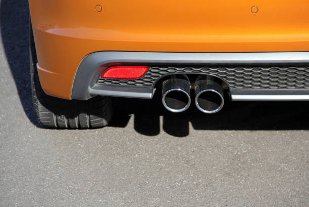 Exhaust pipe system Close up of tailpipe on orange passenger car car classic light tail stock pictures, royalty-free photos & images