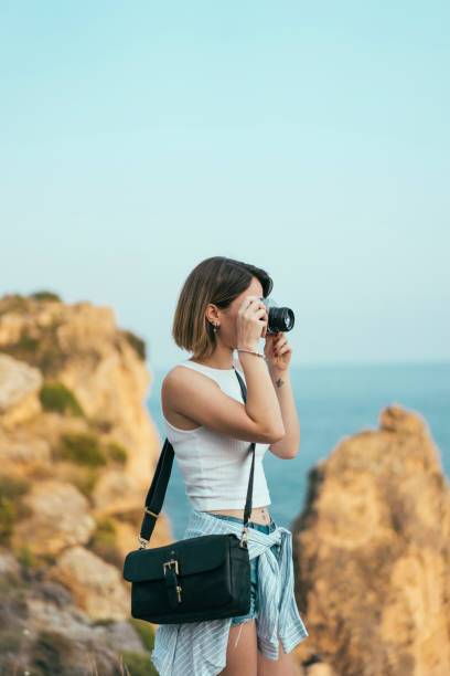 istock Young woman taking a picture 1003739616