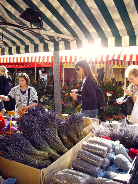 Nice, France - October 16 2008: People shopping in a farmer's market and buying lavender in Nice.