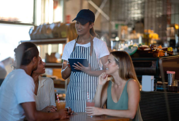 istock Waitress taking the order to a group of people at a restaurant 1003743786