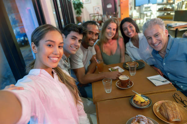 istock Group of friends taking a selfie at cafe 1003747604