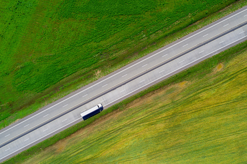Cargo shipping theme. Lorry on highway view from above.
