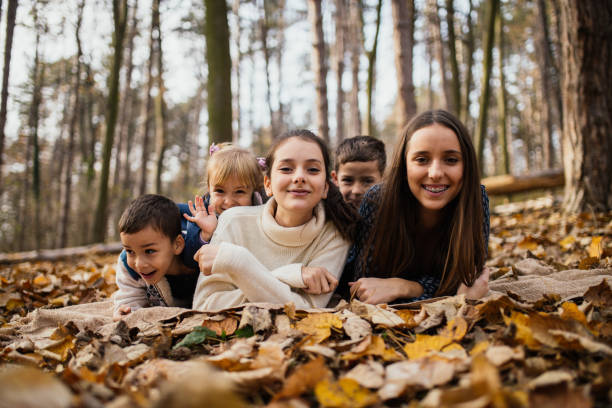 istock Children smiling and posing in park 1003751184
