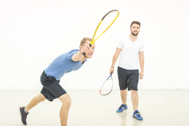 istock Two college buddies playing racquetball 1003751228