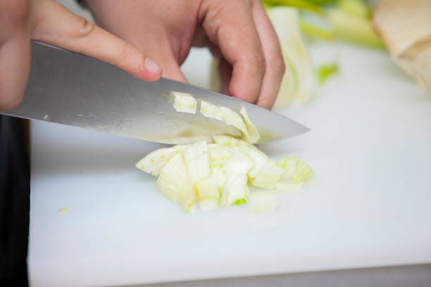 istock The cook cuts greens for salad Close-up 1003751542