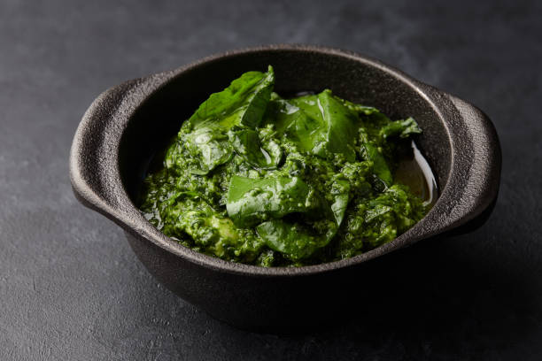 istock Basil pesto sauce in iron mortar, close up view 1003775790